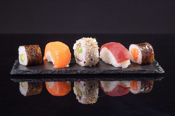 assorted-sushi-served-slate-plate-dark-background-japanese-food